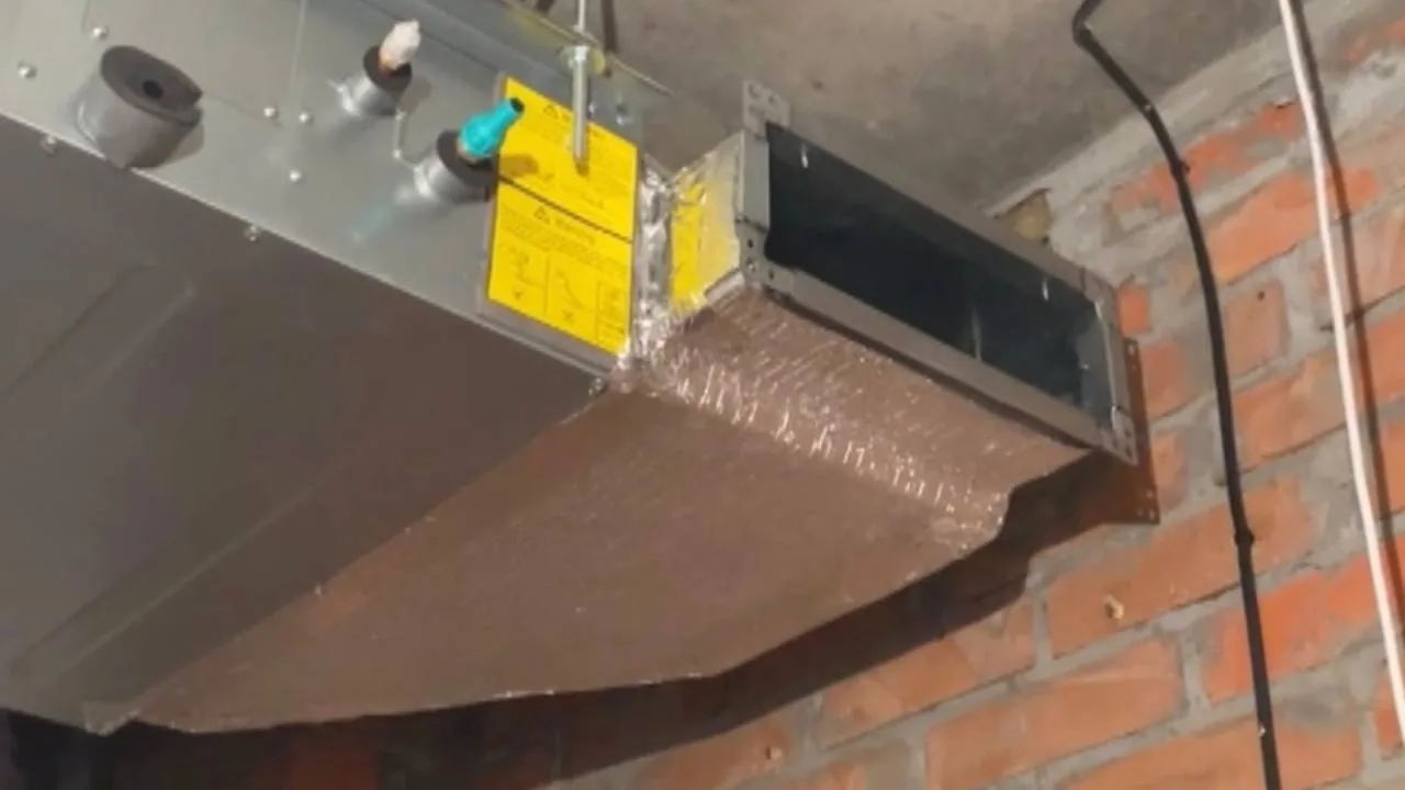 Ducted air-conditioning unit with insulated supply duct connected during installation.